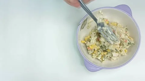 Stirring salad with a fork in a plate isolated on black background with copy Stock-Footage 142877553