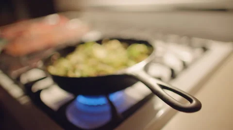Stirring sliced sprouts while they fry 4K Stock Footage 48044470