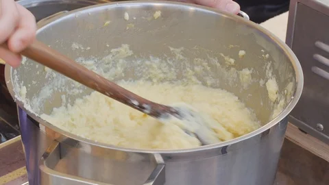 Stirring a small pot of Mashed potatoes on the stove. Video stock 94218841
