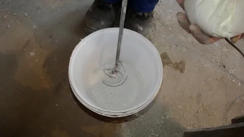 Stirring solution for room repair, dry white solution is mixed with a perforator Stock Footage 88689586