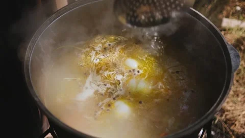 Stirring the soup in a large pot Stock Footage 309952213