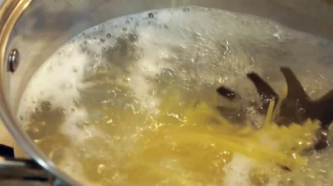 Stirring spaghetti in a boiling water Stock Footage 50311592