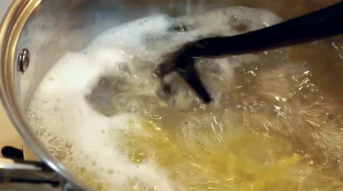 Stirring spaghetti in a boiling water Stock Footage 50311602