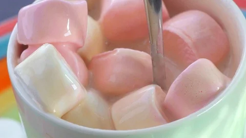 Stirring with a spoon of marshmallow in a Cup Video stock 89588932