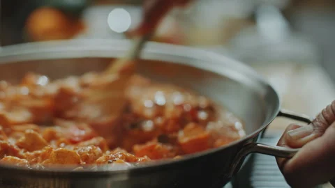 Stirring Steaming Paneer Butter Masala in Pan during Cooking Process Stock Footage 303017853