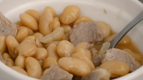 Stirring stewed beans and meat with spoon video 스톡 동영상 336684851