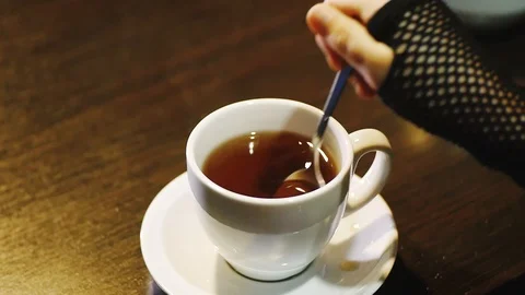 Stirring sugar in a cup of tea Stock-Footage 86100051