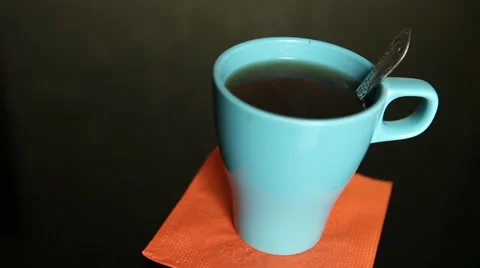 Stirring tea in a blue cup Stock Footage 60423397
