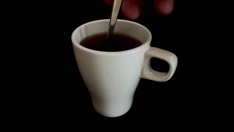 Stirring tea with spoon on black background Video stock 171236501