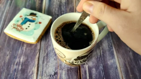 Stirring a teaspoon of sugar in a cup of black coffee Stock Footage 231049468