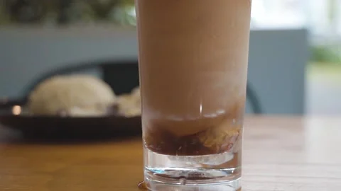 Stirring Teh-C Peng (Iced tea with evaporated milk sweetened with Gula Apong) Stock Footage 210231861