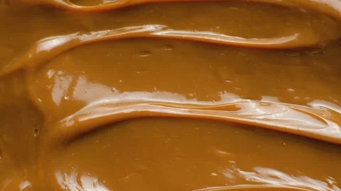 Stirring thick boiled condensed milk with a spoon close up. Stock Footage 331455929