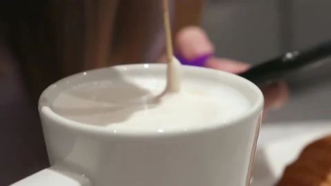 Stirring Thick Foam Of Hot Coffee With Spoon In a  Cup. Stock Footage 222803445