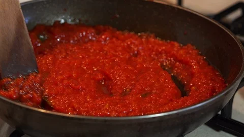 Stirring tomato pulp on cooking pan Stock Footage 127044984