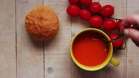 Stirring tomato soup with bread roll Stock Footage 165617588