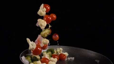 Stirring vegetables in a frying pan Stock Footage 77604217
