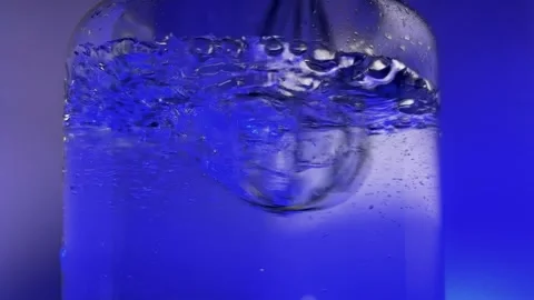 Stirring water, blue light Stock Footage 257480593