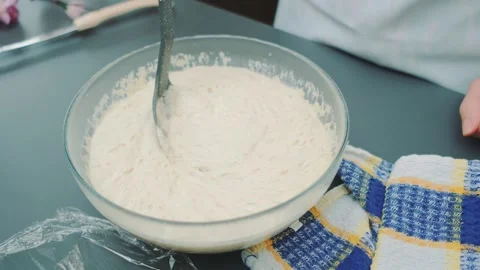 Stirring yeast dough with a large spoon Stock Footage 249079809