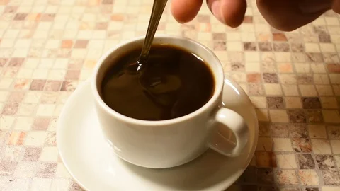 Stirs sugar in a cup of coffee Stock Footage 122681503