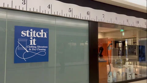 Stitch it sign with a ruler on a display window Video stock 246744651