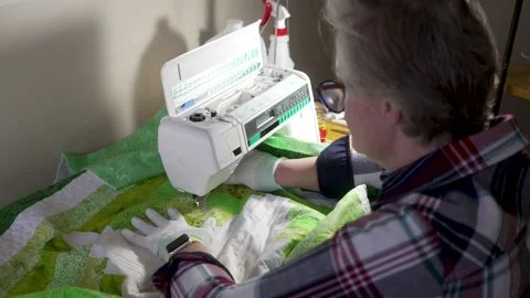 Stitching a decorative pattern on a quilt with a sewing machine Stock Footage 171453614