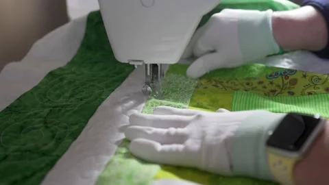Stitching in an intricate pattern on a homemade quilt using a sewing Stock Footage 171453547