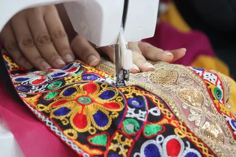 Stitching machine closeup for sewing navratri laces for chaniya choli Stock Photos