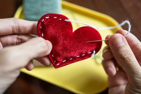Stitching a red heart shape Stock Photos