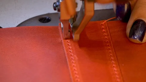 Stitching red leather with sewing machine close up Stock Footage 118135392