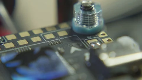 STM32 F722 APP Microcontroller on FPV Circuit Board closeup in drone workshop Stock Footage 318058665