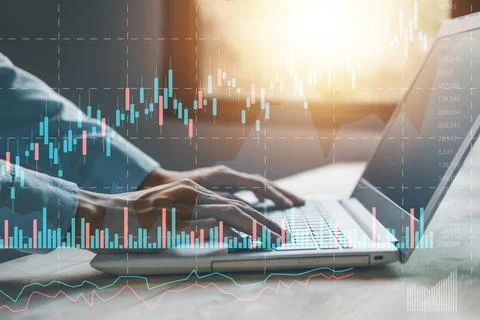 Stock chart or cryptocurrency chart with businessman hand typing notebook (.. Stock Photos