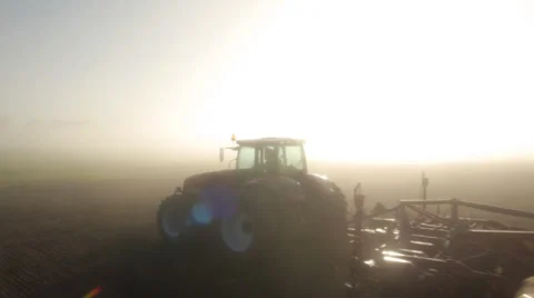 Stock footage, aerial view over the tractor in logs dawn Stock Footage