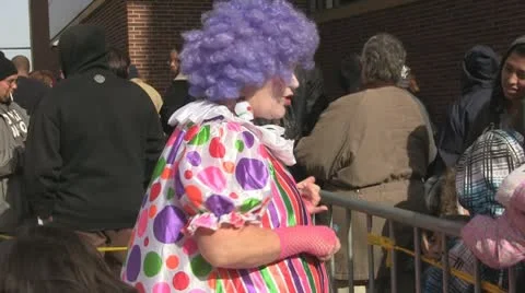 Stock Footage - Economics in America - Clown entertains crowd waiting for food Stock Footage