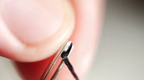 Stock Footage Insert Threading to Needles Eye Macro series Stock Footage 40513315