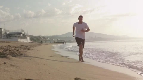 A Male doing Fitness at the Beach at Sunrise Stock Footage