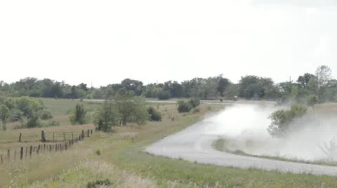 Stock Footage - Truck driving down gravel road leaving a large dust trail Stock Footage