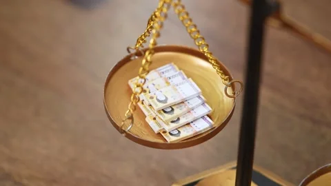 Stock image featuring scales and money Stock Footage 321933591