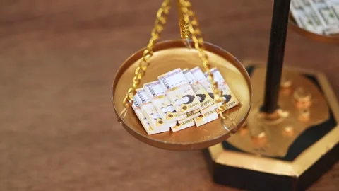 Stock image featuring scales and money Stock Footage 321934243