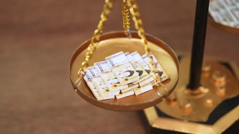 Stock image featuring scales and money Stock Footage 321934937