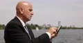 Stock Market Agent Outside Office Use Tablet Check Schedule Business Meeting Day 4k or 4k+ Resolution