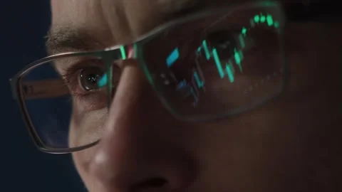 Stock market chart reflected in traders glasses  Stock Footage 305264050