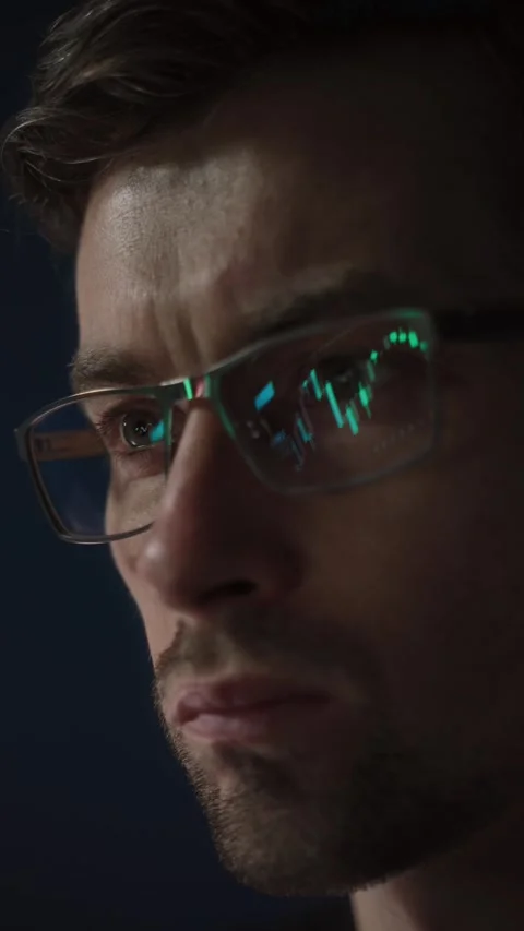 Stock market chart reflected in traders glasses  Stock Footage 305264056