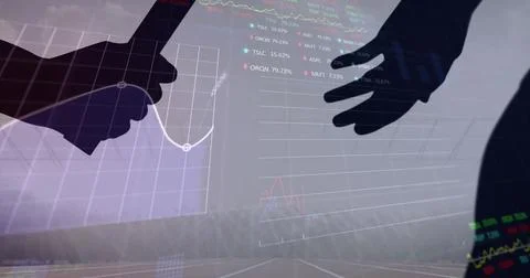 Stock market data processing against silhouette of hand passing a baton against 스톡 사진
