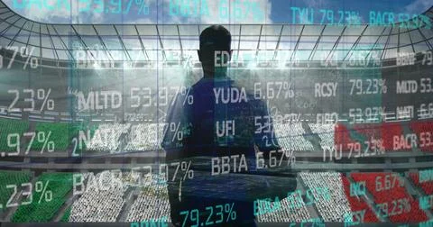 Stock market data processing over rear view of male rugby player against sports Foto stock