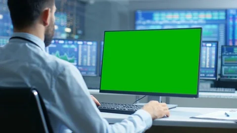 Stock Market Trader Working on a Computer with Green Screen. Stock Footage 81703631