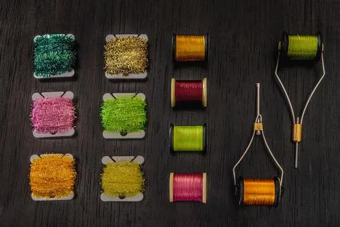 Stock photo of an array of spools for fly tying, a popular hobby associated with Fotos de archivo