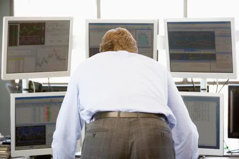 Stock Trader Looking At Multiple Monitors Stock Photos