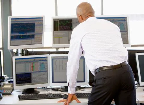 Stock Trader Looking At Multiple Monitors Stock Photos