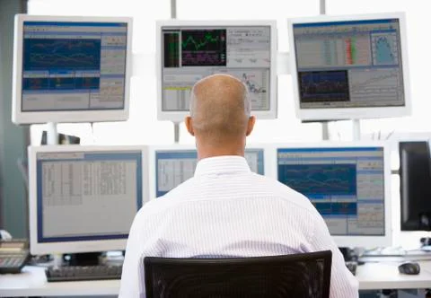 Stock Trader Looking At Multiple Monitors Stock Photos