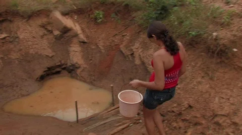 Brazil: Collecting Water From a Mud Hole Stock Footage